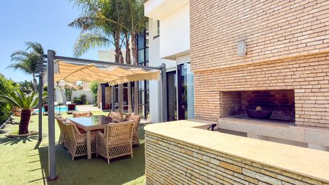 Outdoor dining terrace and fireplace at the Iligh villa