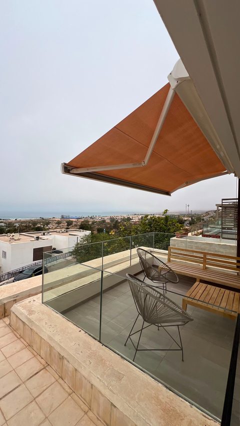 Terrace seating beneath an awning