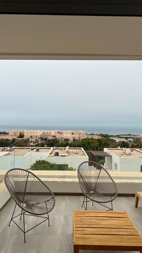 Terrace chairs and table facing the ocean