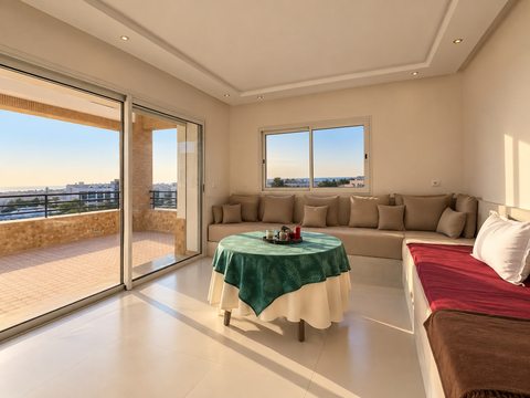 Living room opening onto a terrace at the Imi Ouaddar villa